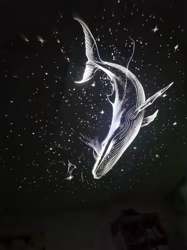 Figura de ballena hecha de estrellas proyectada en la pared